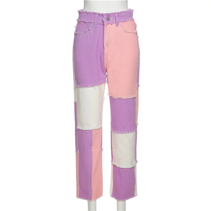 High-waisted patchwork jeans with raw edges in pastel purple, pink, and white colors