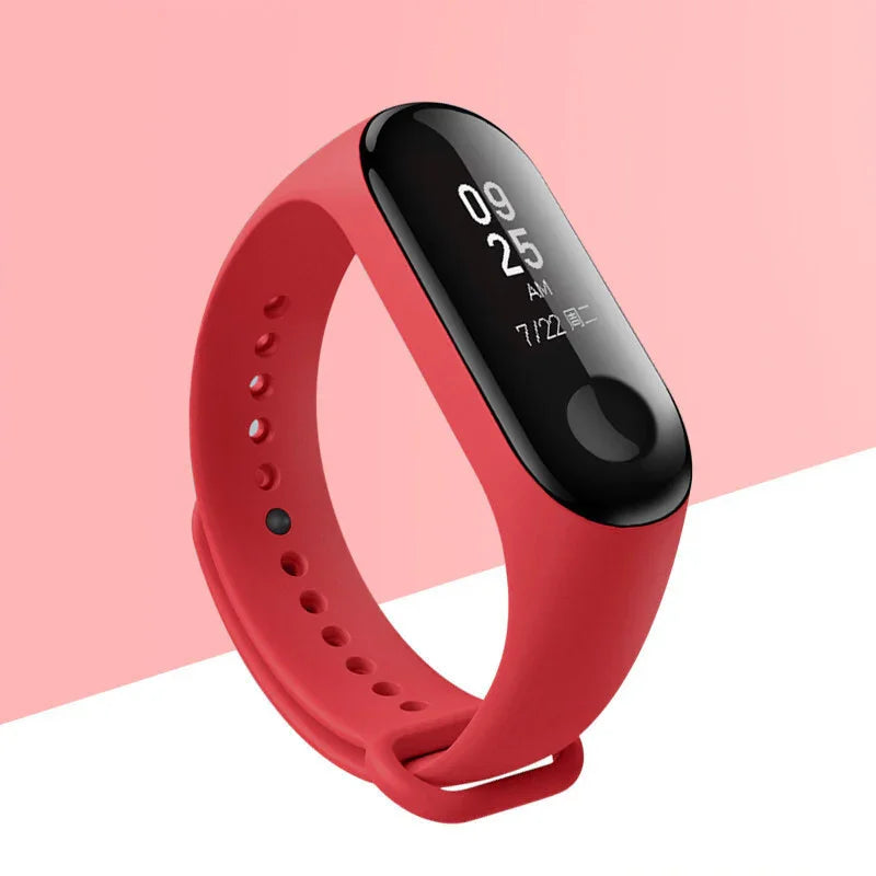 Red fitness tracker with black screen displaying time and date on pink and white background