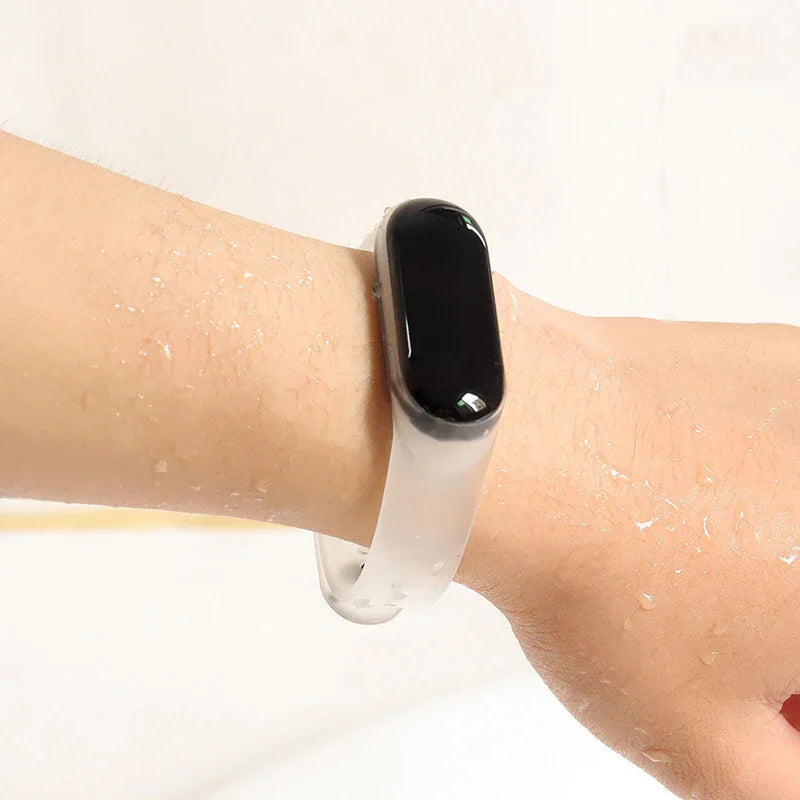 Water-resistant black fitness tracker with clear silicone band worn on wet wrist