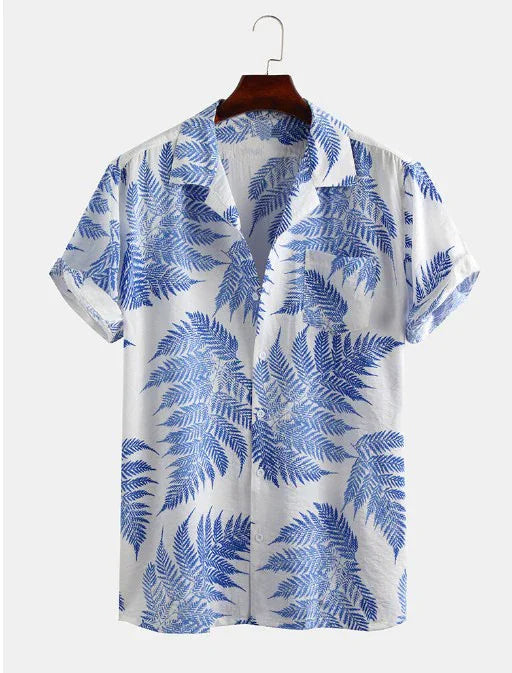 White short-sleeve shirt with blue fern leaf print hanging on wooden hanger