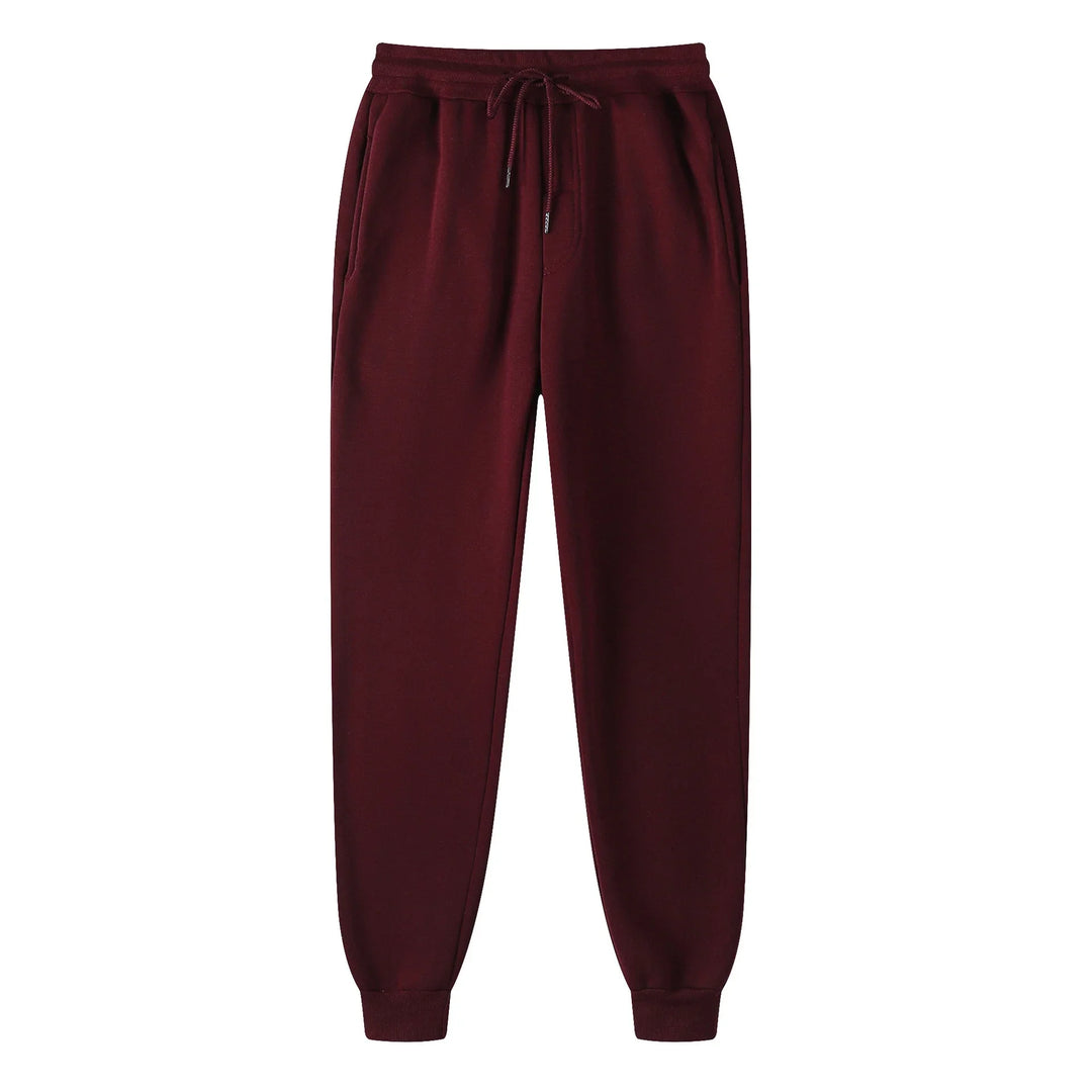 Maroon fleece jogger pants with drawstring waist and side pockets isolated on white