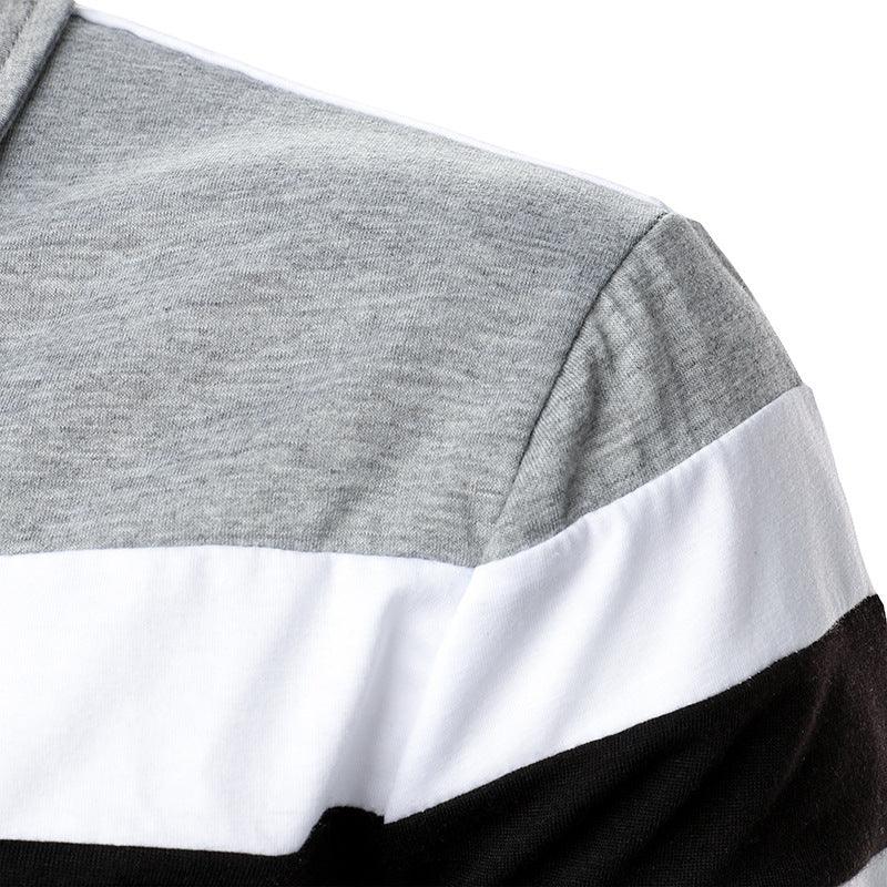 Close-up of grey, white, and black color block fabric on a garment shoulder