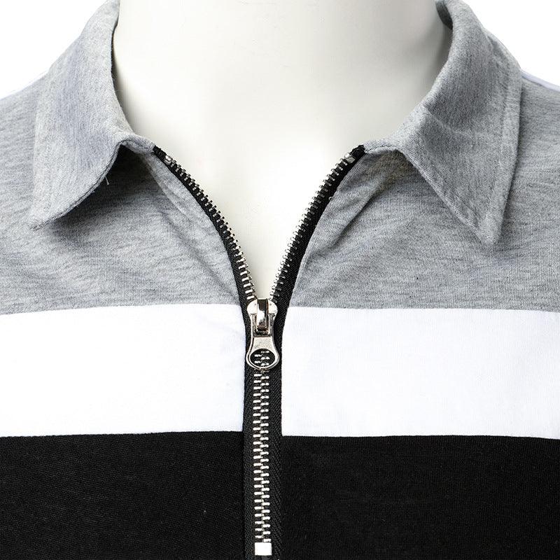 Close-up of grey, white, and black color-blocked pullover with silver zipper and collar