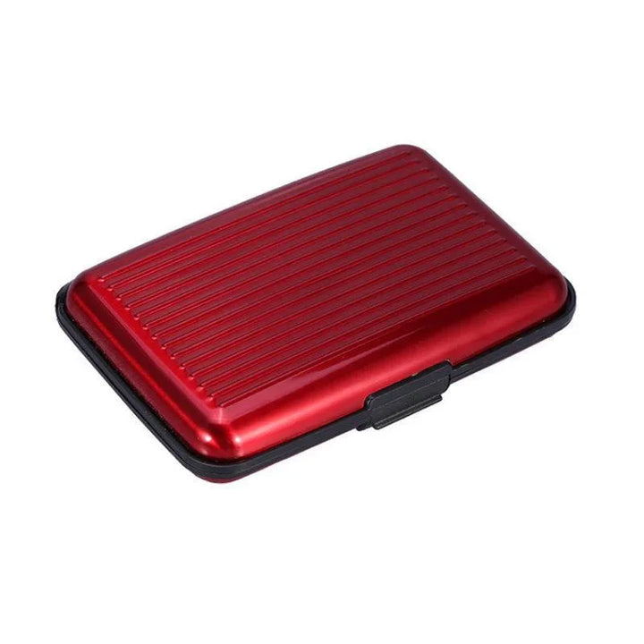 Red metal card holder case with black edges and ribbed top surface on white background