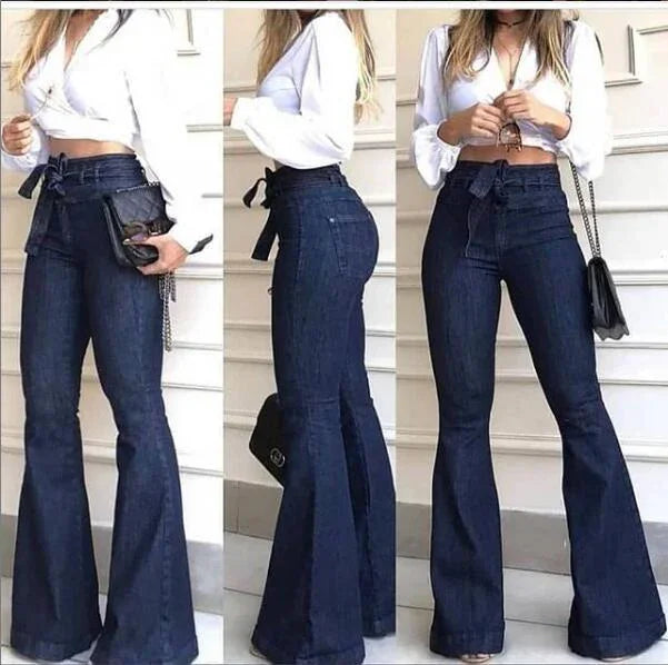 Woman modeling high-waisted dark blue flared jeans with a waist tie and white cropped blouse