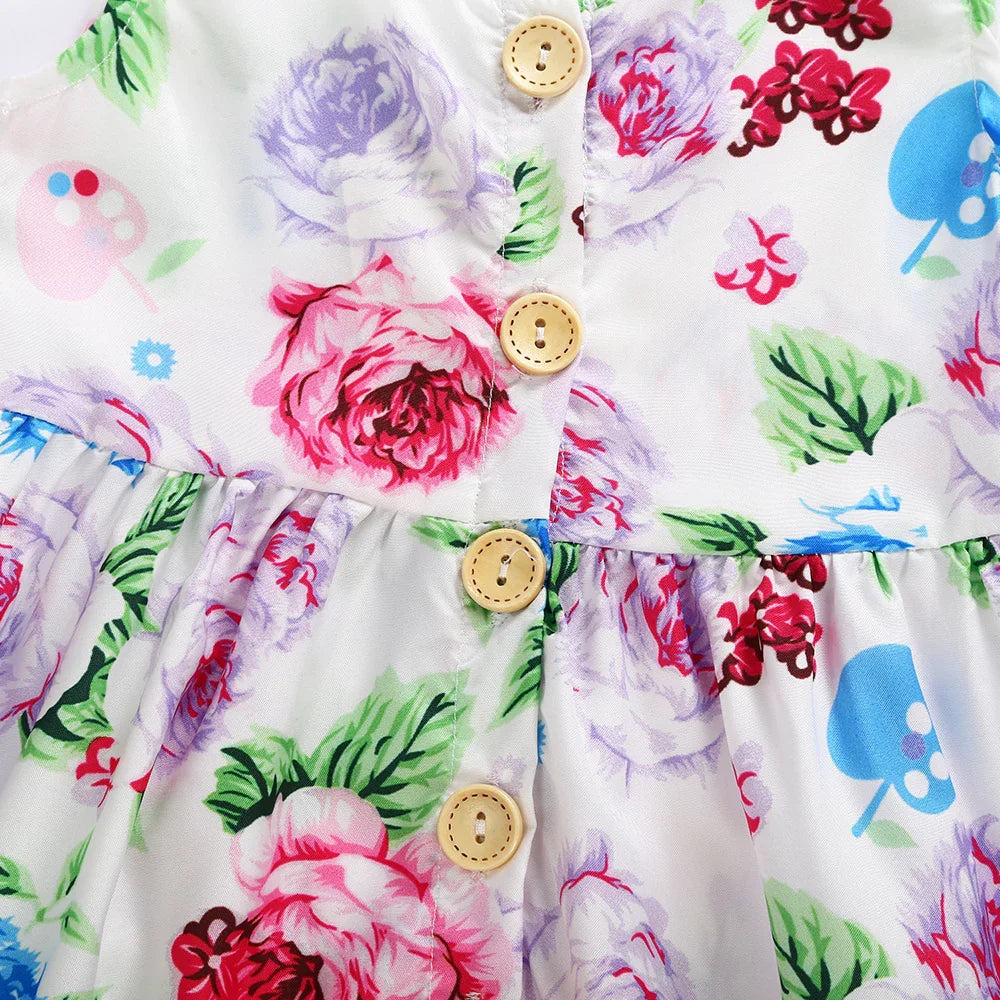 Close-up of white fabric dress with floral pink and purple roses, green leaves, and wooden buttons down the front