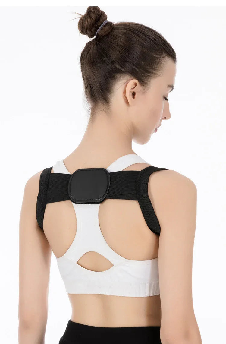 Young woman wearing black posture corrector over white sports bra with bun hairstyle