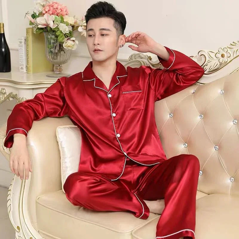 Man relaxing on beige tufted sofa wearing red satin pajamas with white piping in elegant living room