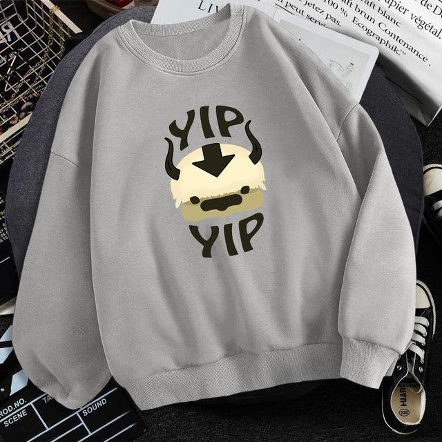 Light gray sweatshirt with cartoon Appa face and text 'Yip Yip' in black and cream colors