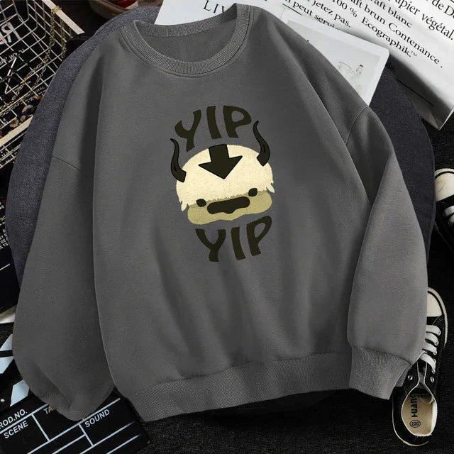 gray sweatshirt with a cartoon buffalo face and black text reading YIP YIP