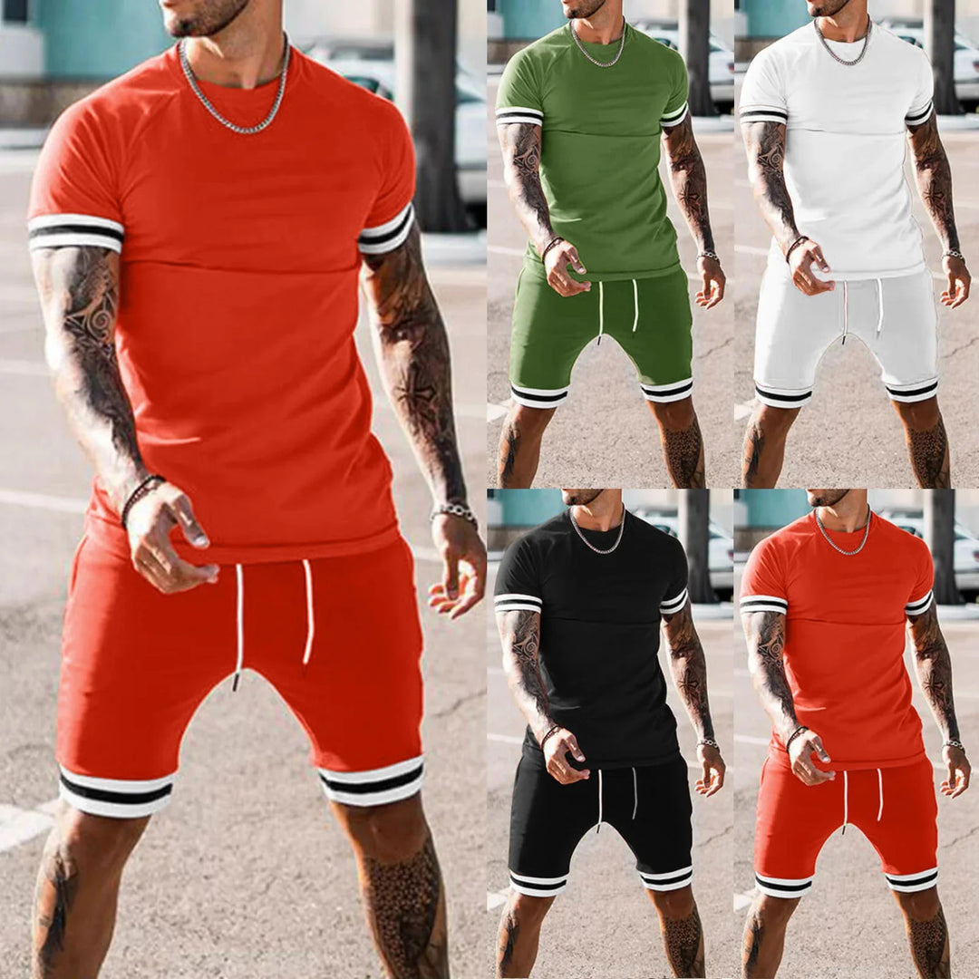 Man wearing sporty casual short sleeve t-shirt and matching shorts in red, green, white, and black colors with striped cuffs