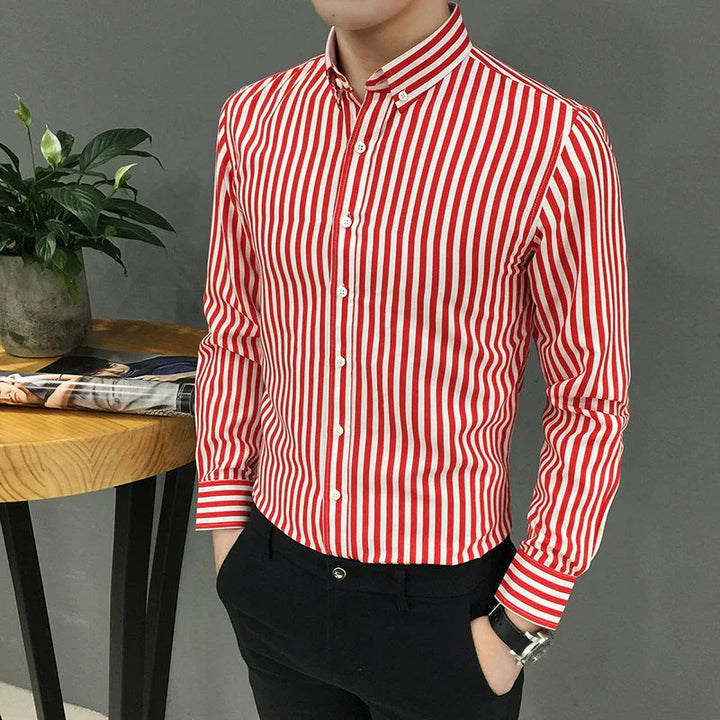 Man wearing red and white vertical striped button-up shirt with black pants and watch