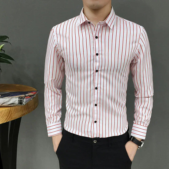 Man wearing white slim fit shirt with red vertical stripes and black buttons, paired with black pants