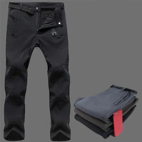 Black waterproof outdoor pants with adjustable waist and zippered fly, folded pants with red phone in pocket