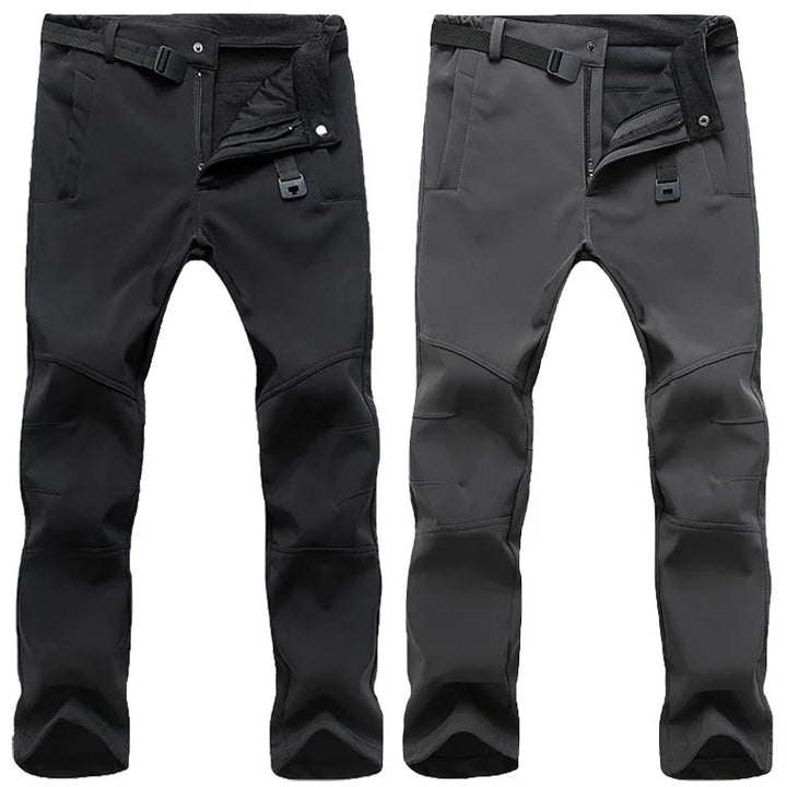 Two pairs of outdoor softshell pants in black and grey with reinforced knees and adjustable waist straps