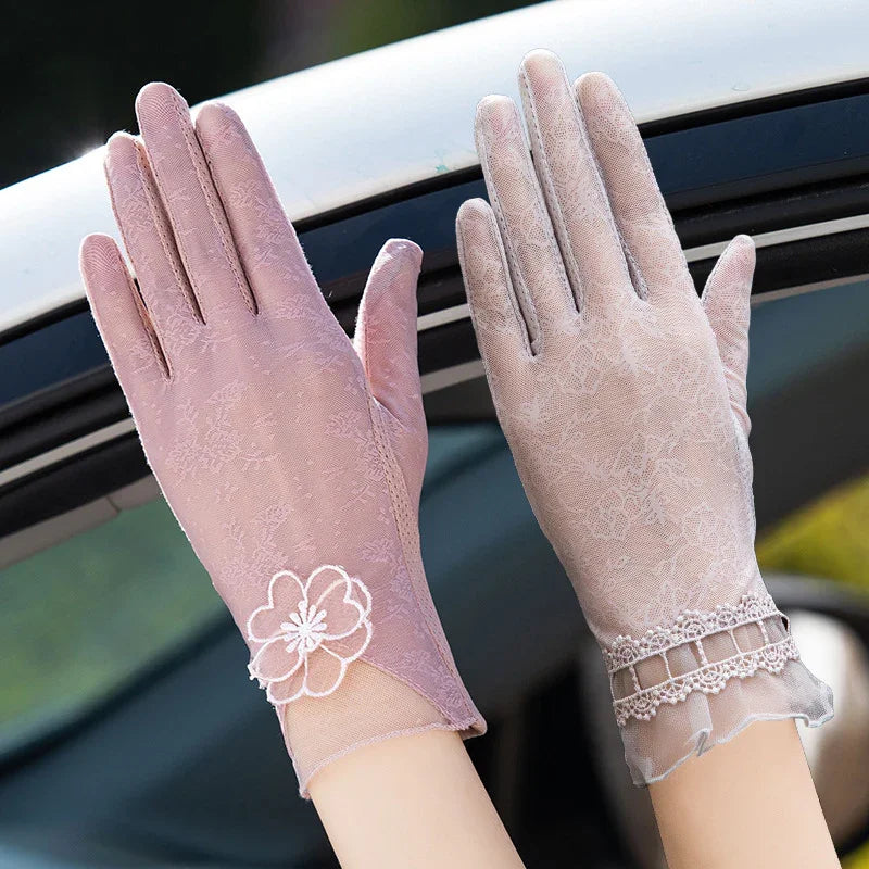 Pair of elegant women's lace gloves in pink and beige with floral and scalloped trim details