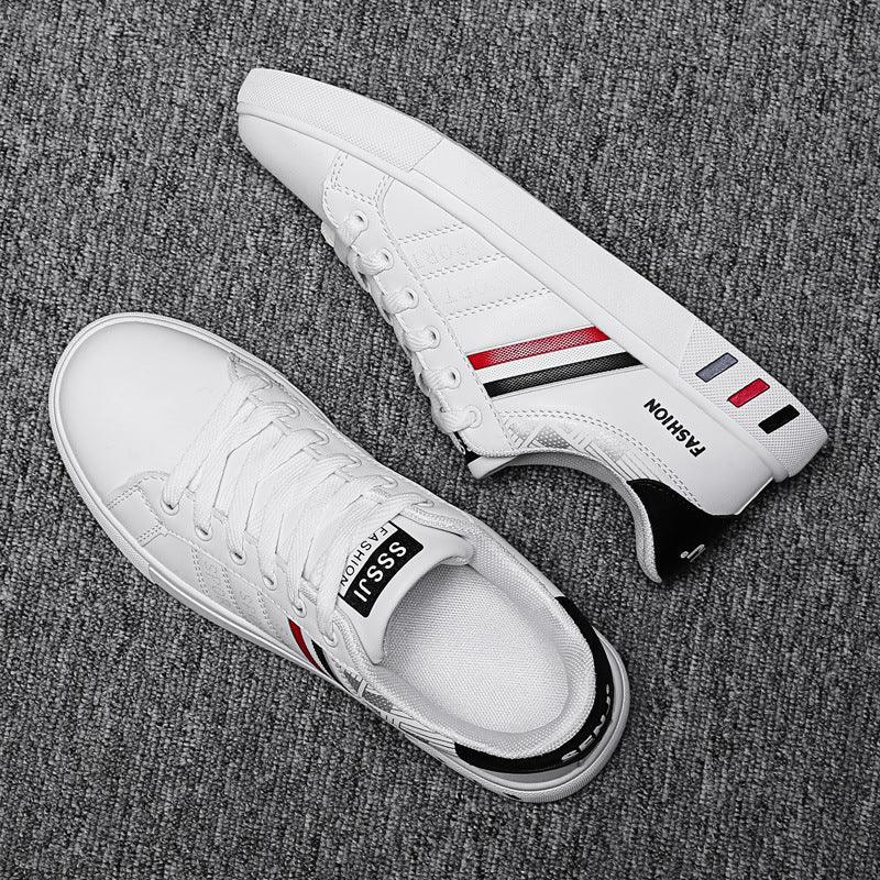 White casual sneakers with red, black, and blue stripes on grey carpet, branded SSsii Fashion