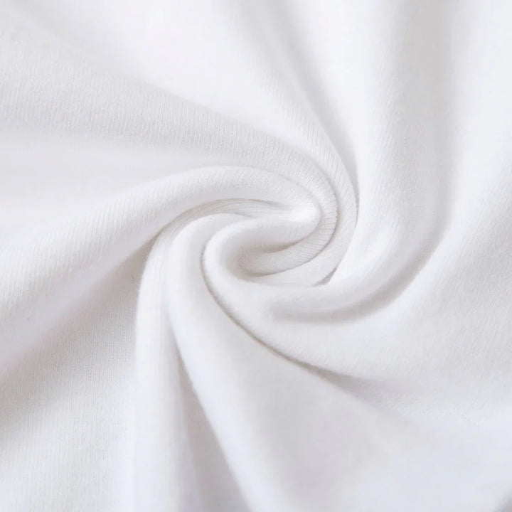 Close-up of soft white cotton fabric with spiral fold texture