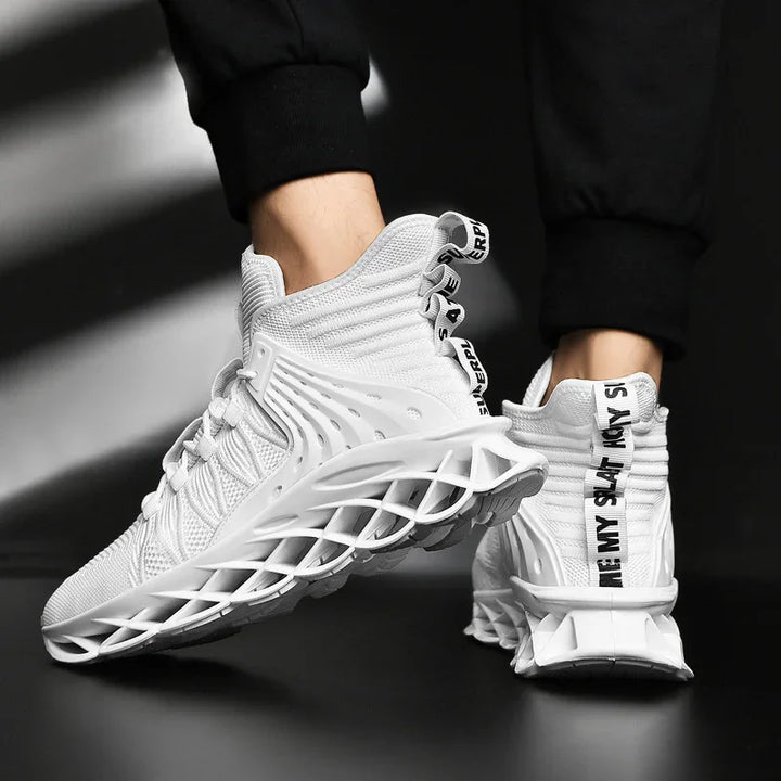 White high-top sneakers with intricate lattice sole design and black lettering on heel pull tabs, worn with black pants