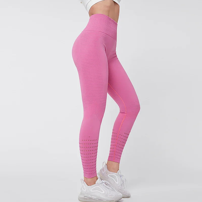 Side view of a person wearing high-waisted pink textured leggings and white athletic sneakers