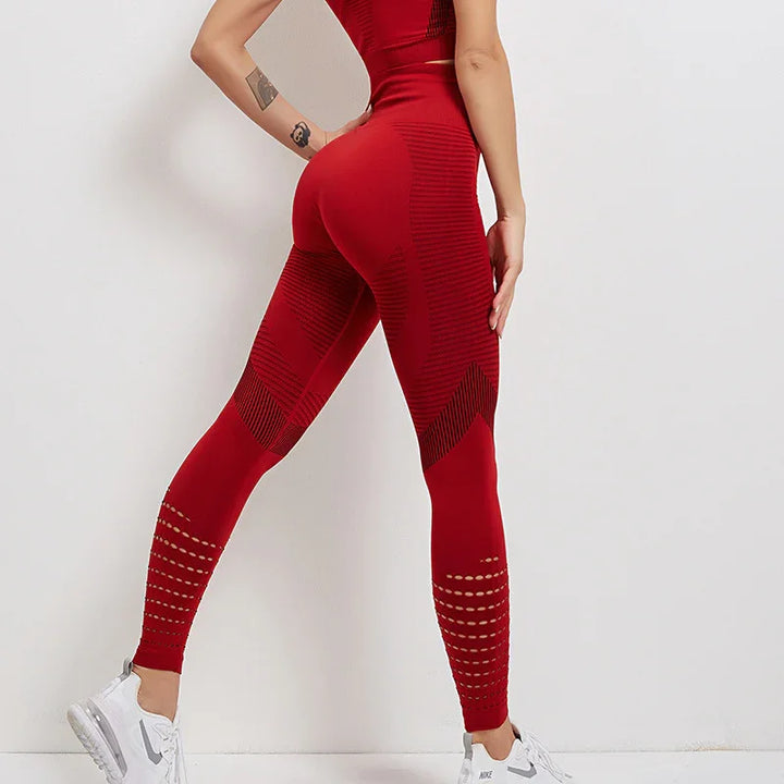 Woman wearing high-waisted red seamless leggings with textured patterns and white Nike sneakers