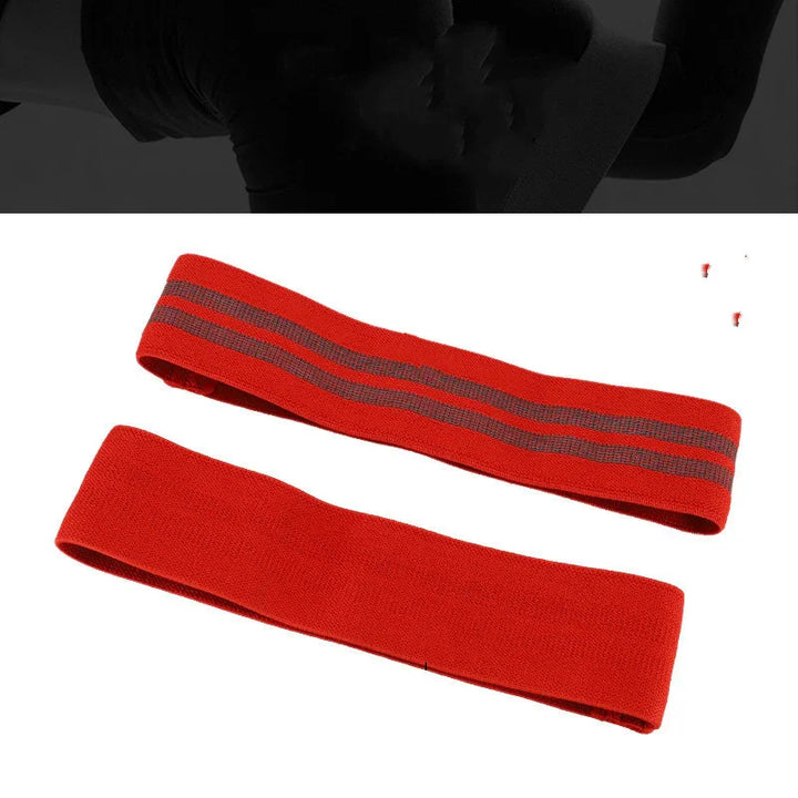 Red resistance bands for fitness and strength training on white background