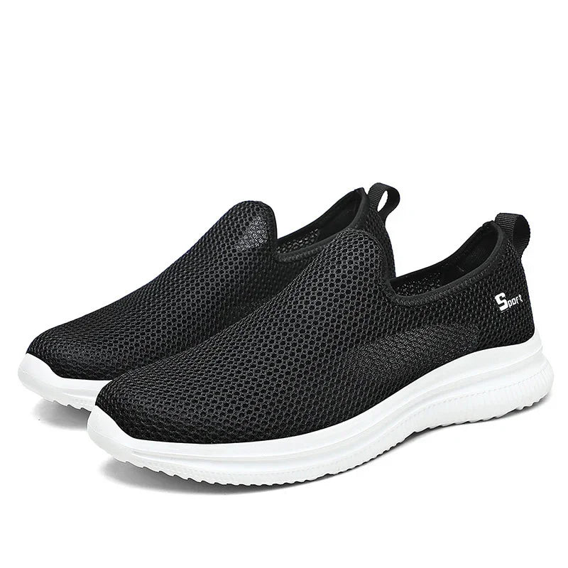 Black breathable mesh slip-on sport sneakers with white sole and pull tabs