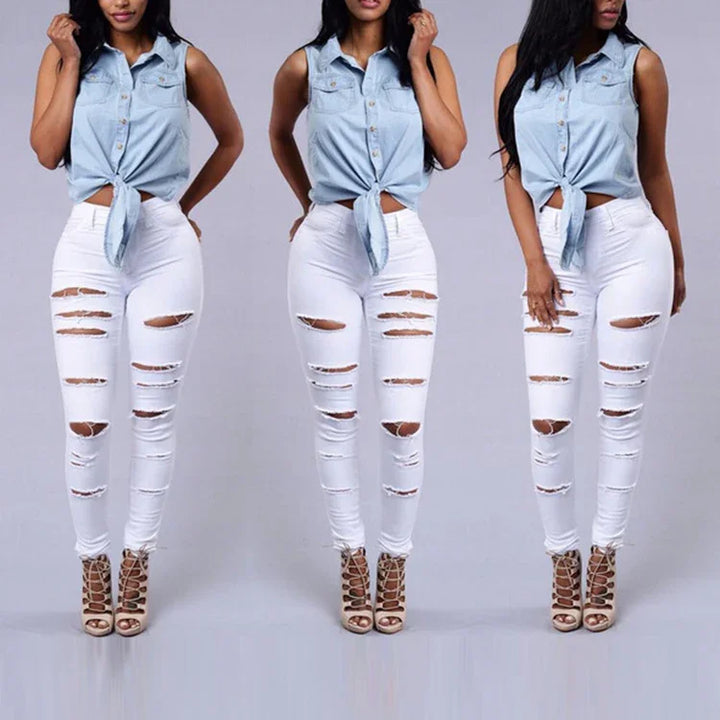 Woman wearing light blue sleeveless tie-front shirt, white ripped skinny jeans, and beige lace-up heels
