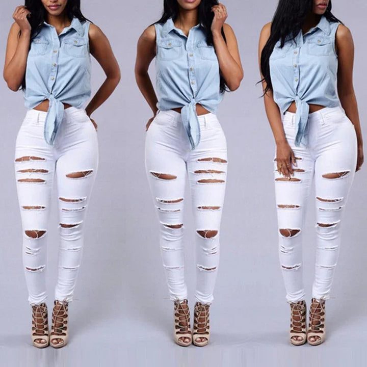 Woman wearing sleeveless light blue tie-front denim top and ripped white skinny jeans with beige lace-up heels