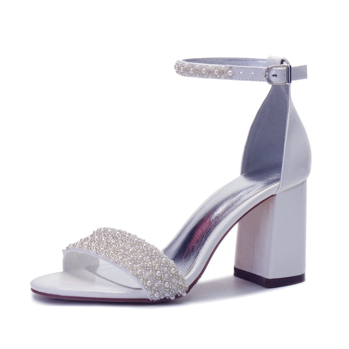White open-toe block heel sandal with pearl-embellished ankle strap and front band