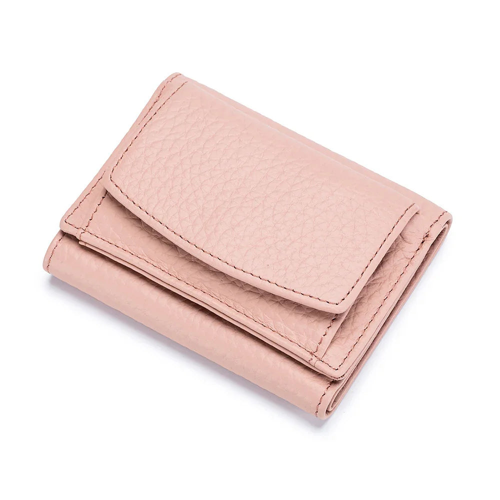 Light pink pebbled leather tri-fold wallet with stitched edges on white background