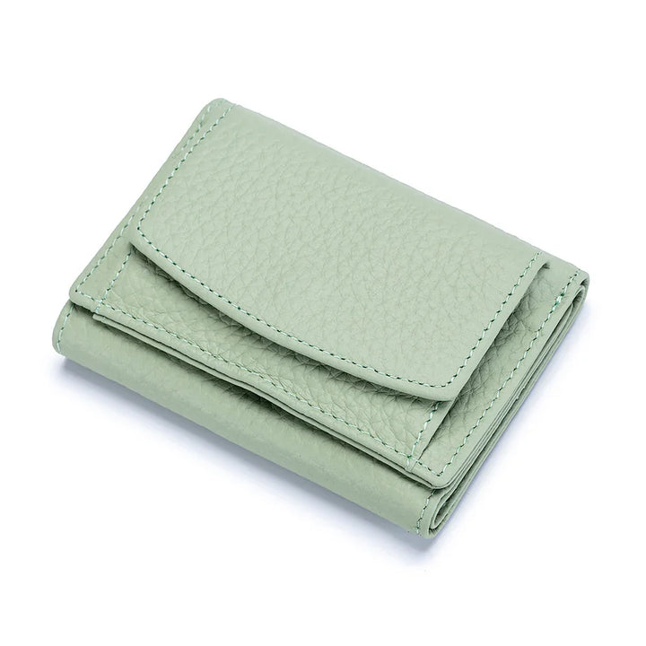 Mint green leather trifold wallet with textured finish on a white background
