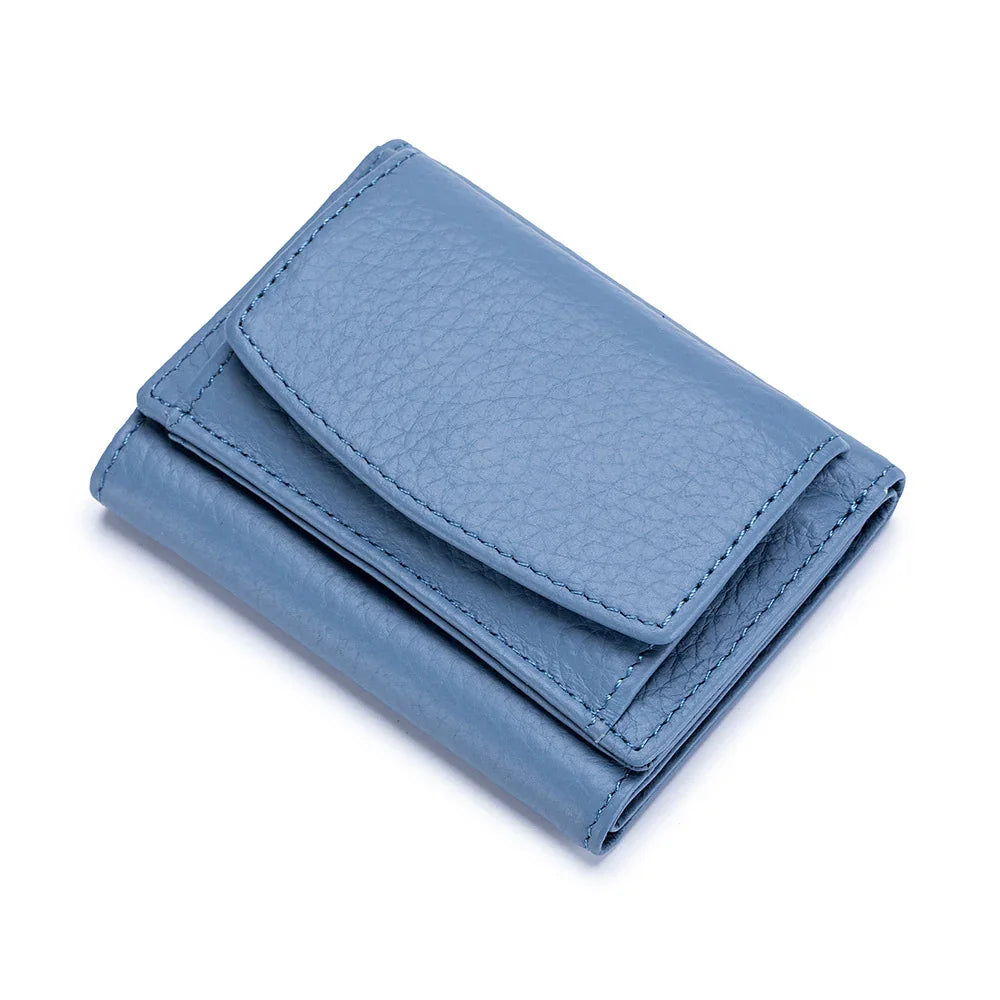 Blue leather tri-fold wallet with textured finish on white background