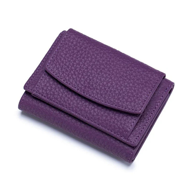 Purple textured leather compact wallet with flap closure on white background