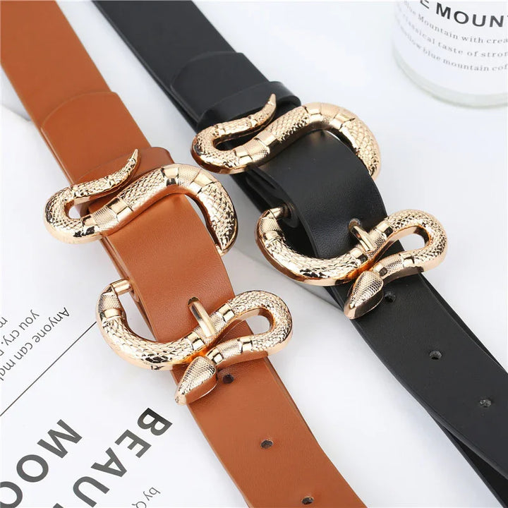 Brown and black leather belts with gold snake-shaped buckles on white surface