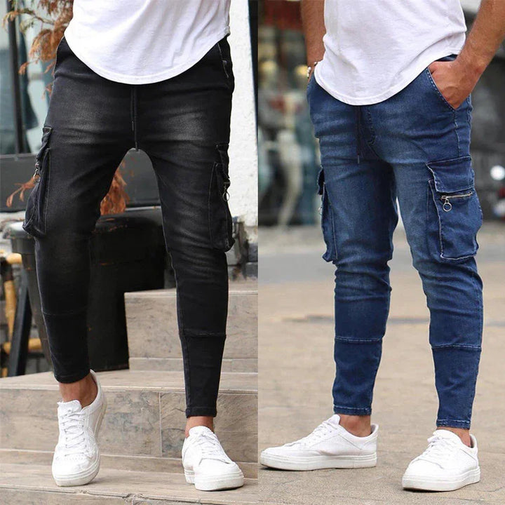 Men's slim fit cargo jeans in black and blue with side pockets, paired with white sneakers