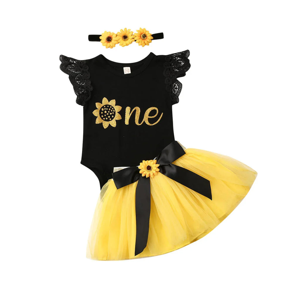 Black baby romper with lace sleeves and gold sunflower one text, yellow tutu skirt with black bow, sunflower headband
