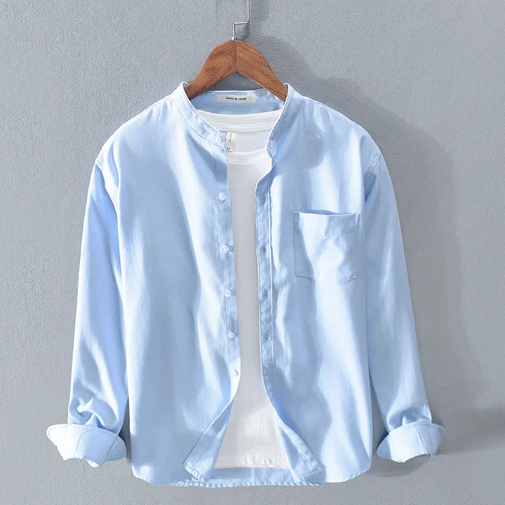 Light blue casual button-up shirt with a white t-shirt underneath on wooden hanger