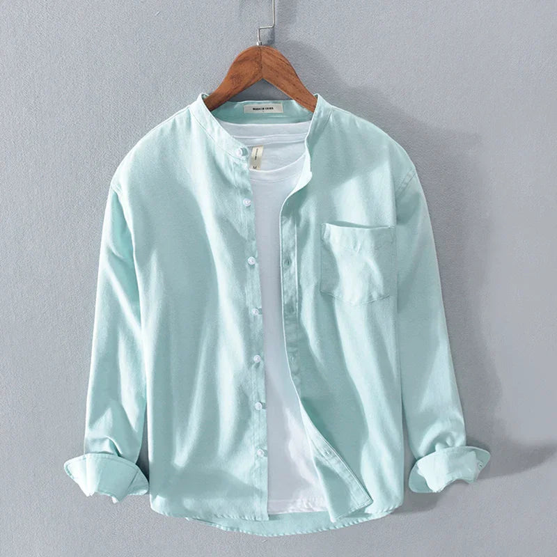 Light blue casual button-up shirt with mandarin collar over white t-shirt on wooden hanger