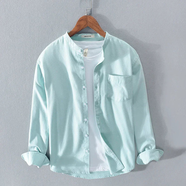Light blue casual button-up shirt with mandarin collar over white t-shirt on wooden hanger