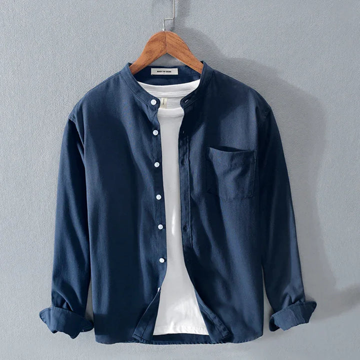 Navy blue casual button-up shirt with white buttons and chest pocket, layered over white T-shirt on wooden hanger
