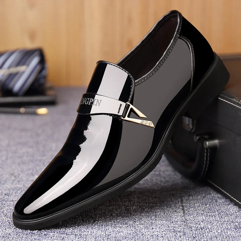 Glossy black patent leather men's dress shoe with gold triangular buckle detail