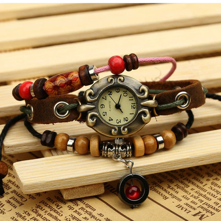 Vintage quartz wristwatch with decorative bronze frame and leather strap, adorned with wooden beads and red accents