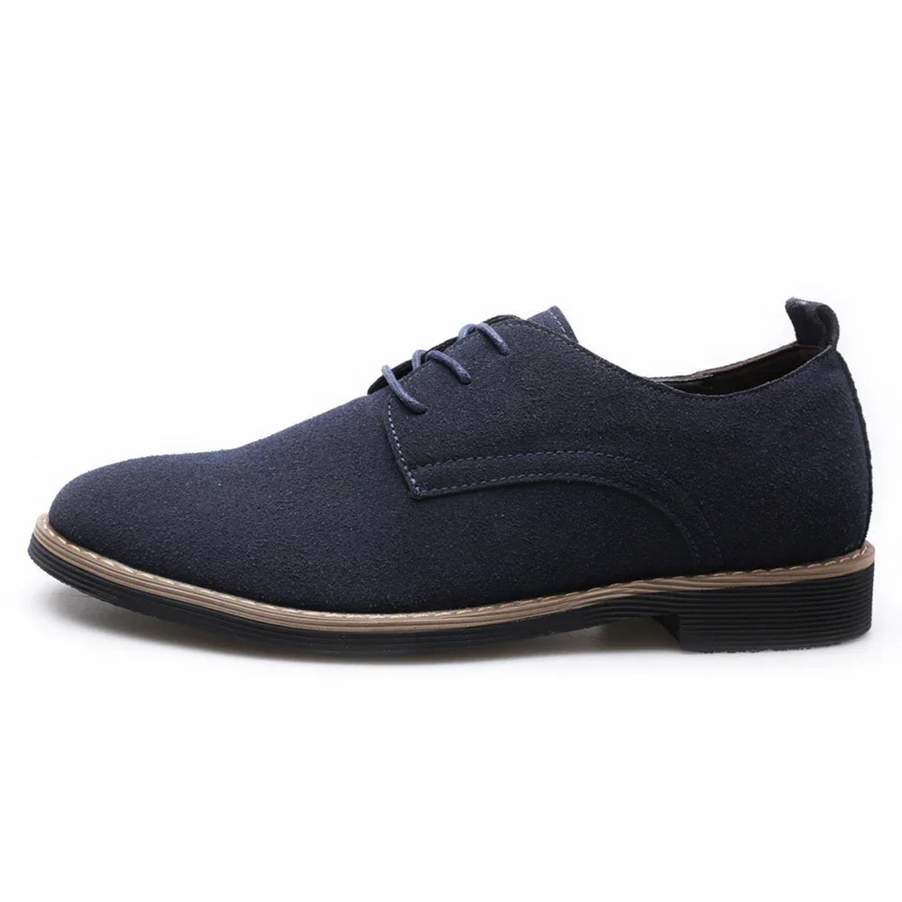 Navy blue suede men's derby shoes with tan stitching and black rubber soles