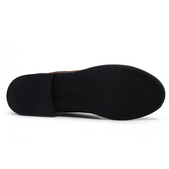 Black sole of a brown leather dress shoe on white background