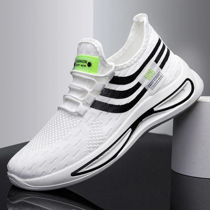 White knit sports sneaker with black stripes and neon green labels on a reflective surface