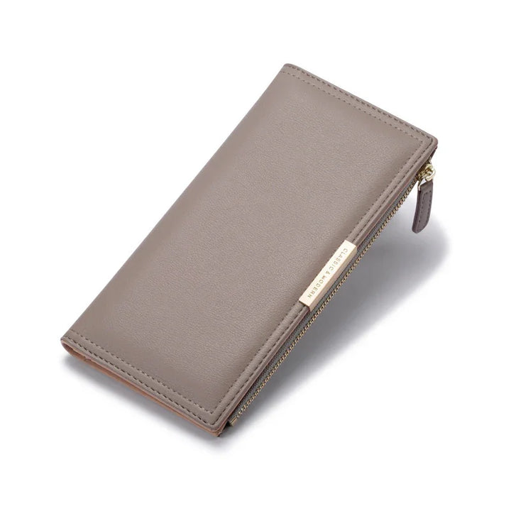 Taupe leather zip-around wallet with gold Classic & Modern logo plate on white background