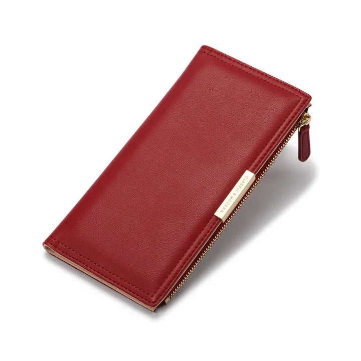 Elegant red leather wallet with gold zipper and minimalist design on white background