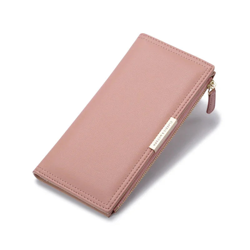 Pink leather zip-around wallet with gold-tone zipper and classic design tag