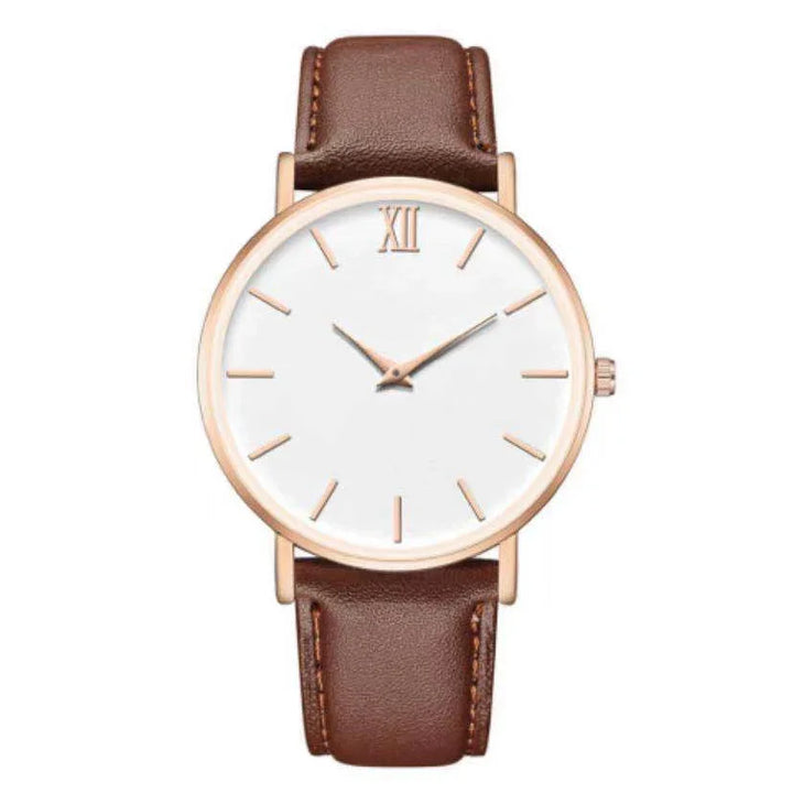 Minimalist wristwatch with white dial, rose gold case, Roman numeral XII, and brown leather strap